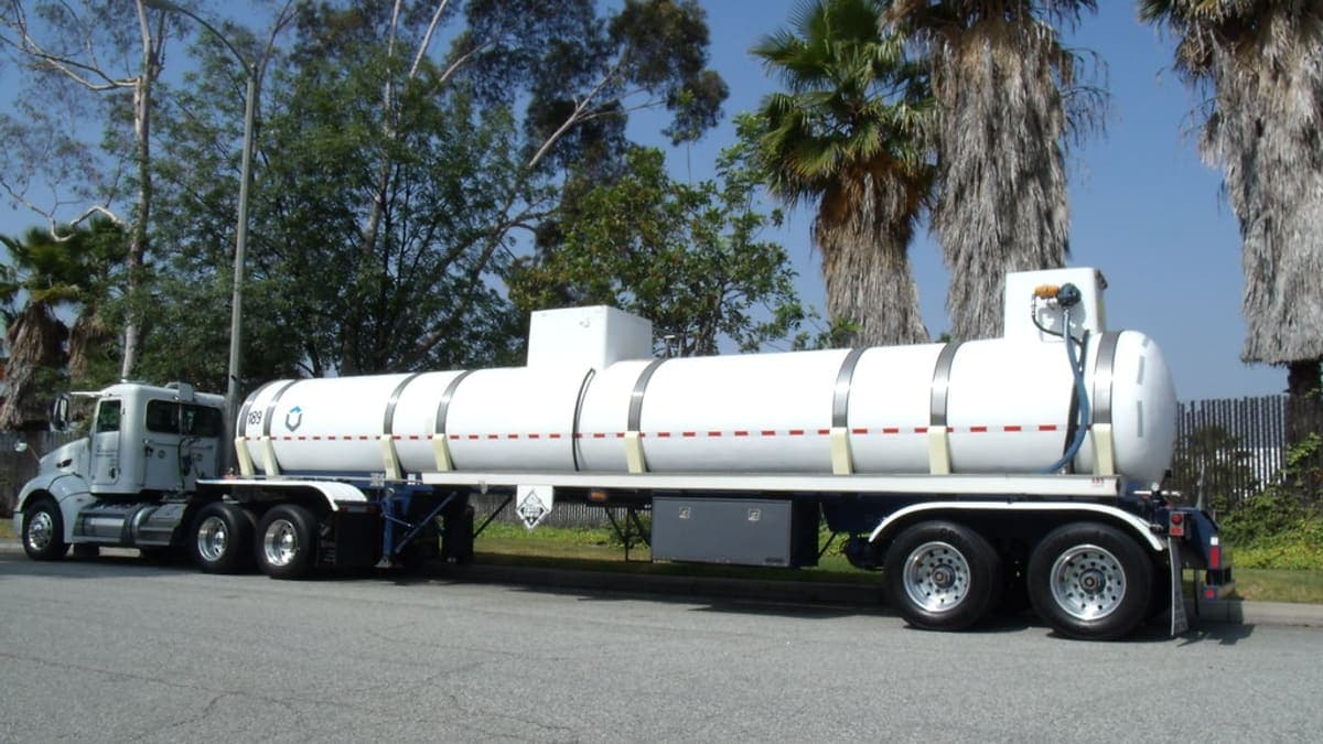 A fuel pump at a filling station with a lorry nearby